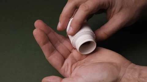 Close-Up Shot of Pills Being Poured into a Hand Stock Footage 342237707