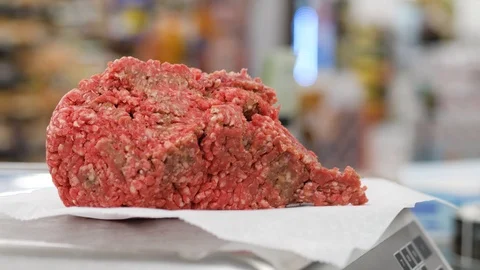 Close up shot of placing minced meat on the scales in order to check weight Stock-Footage 104950258