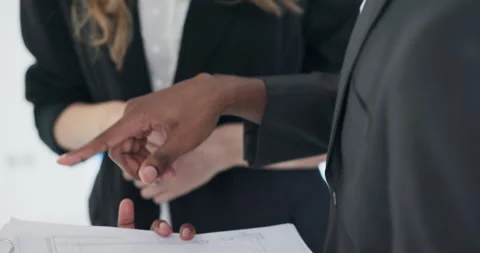 Close up shot on plan of the house potential customers discussing the pan of the Stock Footage 277683741