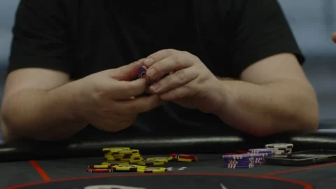 A close-up shot of a player moving poker chips on table Stock Footage 336240110