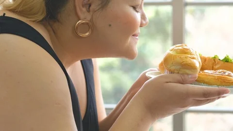 Close up shot of plus size or big size girl  smells high calorie food Stock Footage 120719911