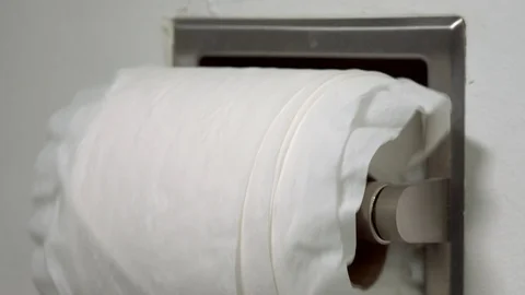 Close up Shot of a Poorly Rolled Roll of Toilet Paper Unrolling Video stock 128783161