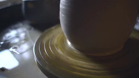 Close up shot of a pot rotating on pottery wheel. Sculpting a shape of clay item Video stock 145070678