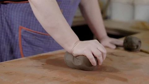 Close up shot of the potter's hands, the master kneads the clay piece in the Video stock 88860498