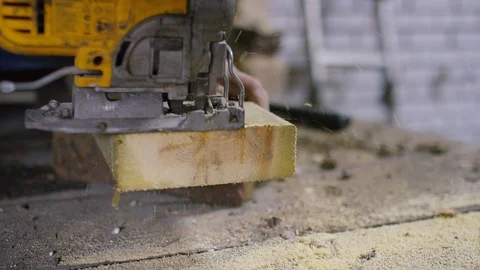 Close up shot of power tool cutting through a block of wood, in slow motion  Stock Footage 110804222