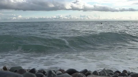 Close-up shot of powerful sea wave crashing onto pebble beach Stock Footage 336178259