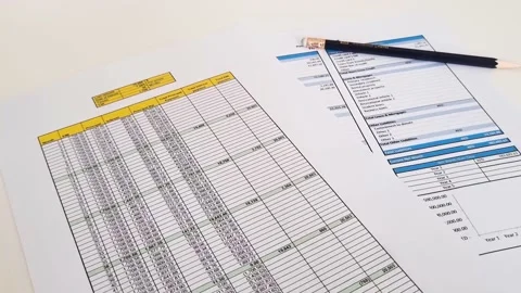 Close up shot of a print outs of excel table of a bank loan amortization tabl Stock Footage 210505116
