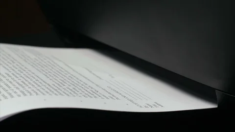 Close up shot of a printer printing out papers Stock Footage 113334147