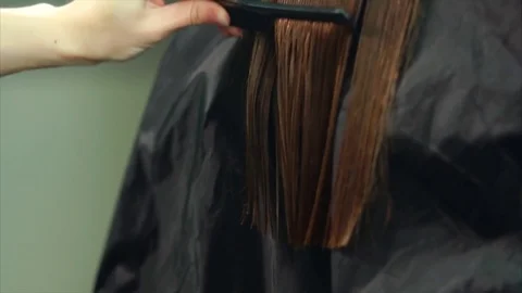 Close up shot of the process of cutting split ends of hair in a beauty salon Stock Footage 77158785