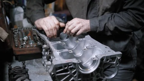 Close up shot of a professional mechanic disassembling engine block in car Video stock 83141211