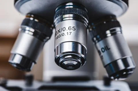 Close-up shot of professional scientific microscope with metal lens setting.. Photos