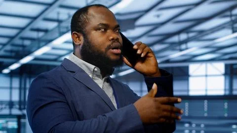 Close up shot of programmer in data center talking in phone call Stock Photos