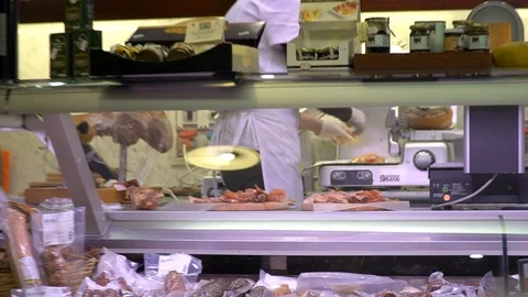Close up shot of prosciutto ham slicing in an Italian Delicatessen shop of Italy Stock Footage 89783098