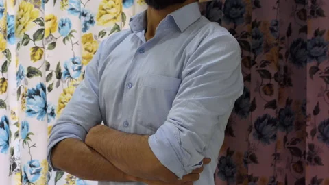 Close shot of a proud man standing with folded hands and talking to someone Stock Footage 147329705