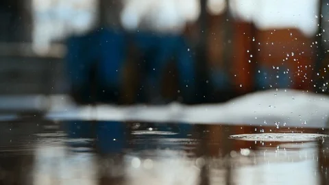 Close up shot of a puddle in which big drops fall and blurs 스톡 동영상 108580585
