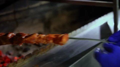 Close up shot of the putting meat en brochette on the inside grill Stock Footage