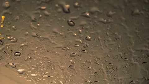 Close up shot of rain droplets on car windshield. Video stock 152010940