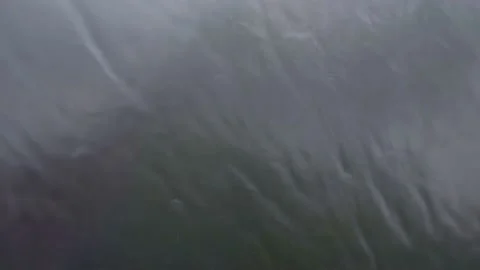 A close up shot of rain drops on window glasses surface. Natural Pattern Video stock 203931350