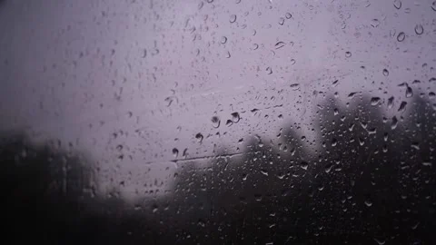 Close-up shot of raindrops running down the glass of a car Stock Footage 139364543