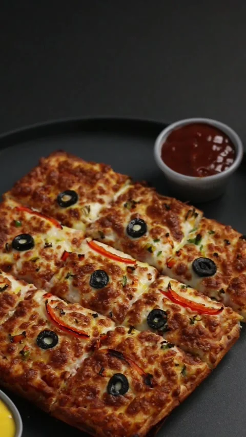 Close-up shot of a rectangular pepperoni pizza with melted cheese 스톡 동영상 307058518