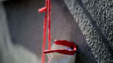 Close-up shot on red boxing gloves hanging on a rough concrete wall Stock Footage 105649382