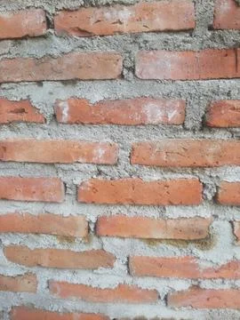A close-up shot of a red brick wall shows the texture and pattern, providing Stock Photos