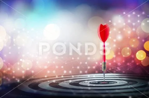 Close up shot red dart arrow on center of dartboard over bokeh background Stock Photos