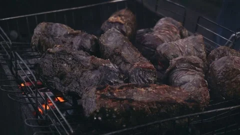 Close-up shot of red meat and chicken legs grilled during picnic Video stock 84019136