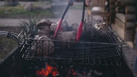 Close-up shot of red meat and chicken legs grilled during picnic Video stock 84020017