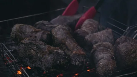 Close-up shot of red meat and chicken legs grilled during picnic Video stock 84254144