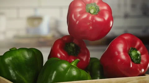 Close up shot of red pepper falling on a basket in slow motion Stock Footage 152903140