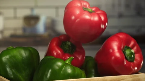 Close up shot of red pepper falling on a basket in slow motion Stock Footage 152904638