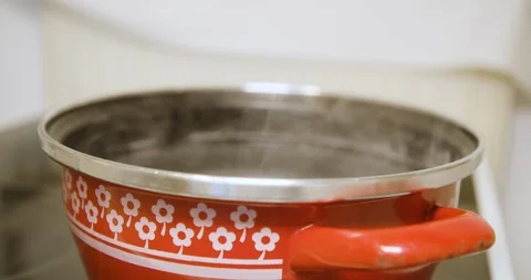 Close up shot, red retro cooking pot with boiling water and steam Stock Footage 124883398