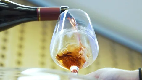 Close up shot, red wine being poured into wine glass. Stock Footage 120843592