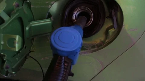 Close up shot of refilling nozzle in automobile tank at fuel station Stock Footage 73616726