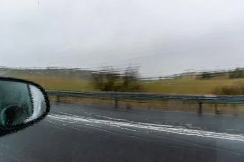 A close-up shot of the reflection of a white van in the rearview mirror of a  Stock Photos
