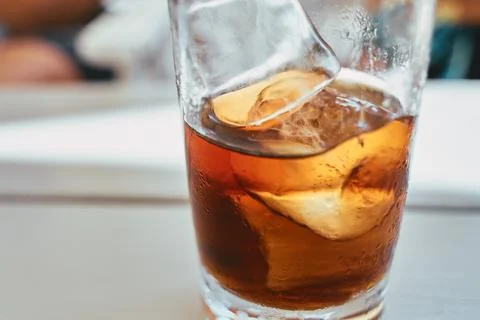 Close-up shot of a refreshing cold carbonated brown beverage with ice cubes.. Stock Photos