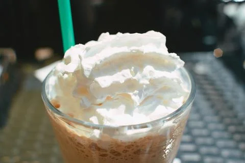 A close-up shot of a refreshing iced coffee beverage topped with whipped cr.. Stock Photos