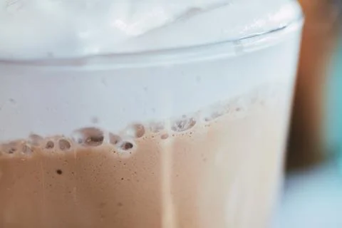 Close-up shot of a refreshing iced coffee beverage topped with thick creamy.. Stock Photos