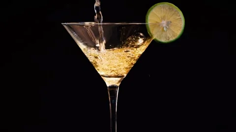 Close-up shot of refreshing yellow alcoholic drink being poured into a mart.. Video stock 332688017