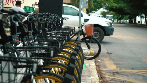 Close up shot. Rental sharing system bicycles in Mexico. Street with cars. Stock Footage 168153928