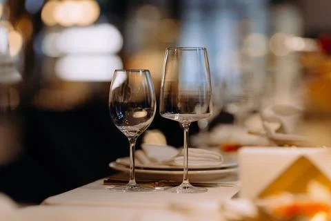 A close up shot of a restaurant table set up with tableware and wine glass. C Stock Photos
