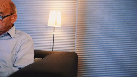 Close up shot of retired man spending his time playing with his mobile phone Stock Footage 99014151