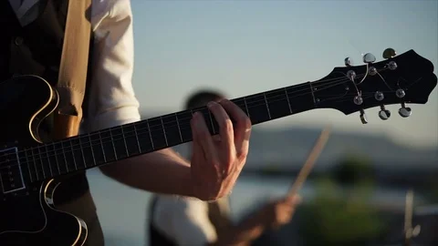 Close up shot of the rhythm guitar, a man plays with the help of a mediator Stock Footage 80202206