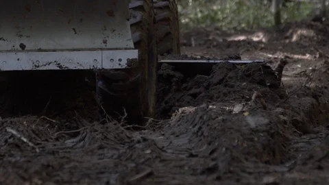 Close up shot of Road leveling motor grader on bad forest road at work Stock Footage 126380135