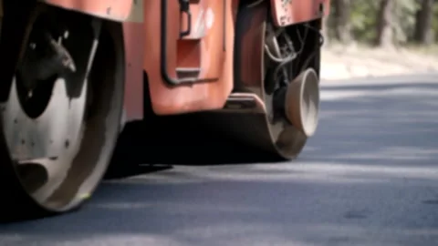 Close-Up Shot Of A Road Roller Driving On A Tarmac Road In A Forest Stock-Footage 141997205