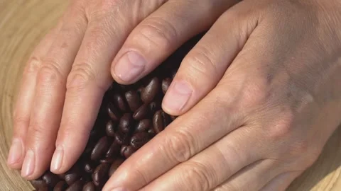 Close-Up Shot of Roasted Coffee Beans Falling off From Hands Stock Footage 137771085