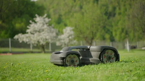Close up shot - Robot lawn mower mowing grass on a large plot of land Stockbeeldmateriaal 270228984
