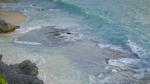 Close up shot of rocks in sandy tropical beach in high tide Stock Footage 113552038