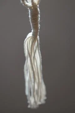 Close-up shot of a rope featuring a complex knot Stock Photos